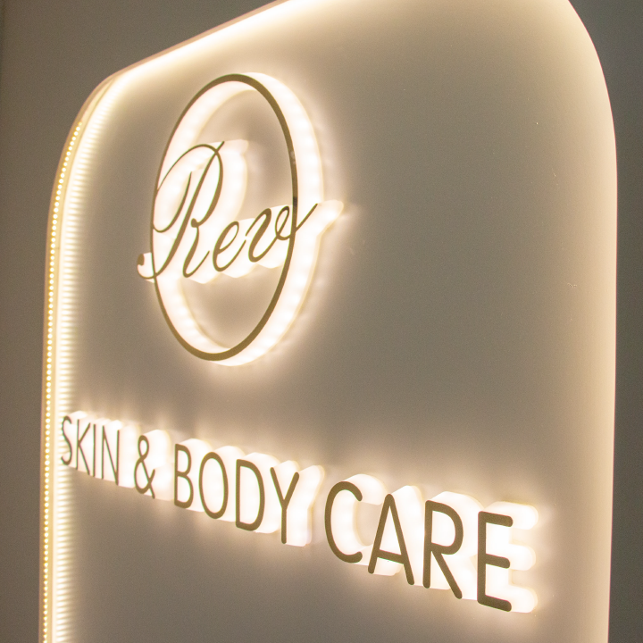 Close-up of the illuminated Reve Skin & Body Care sign